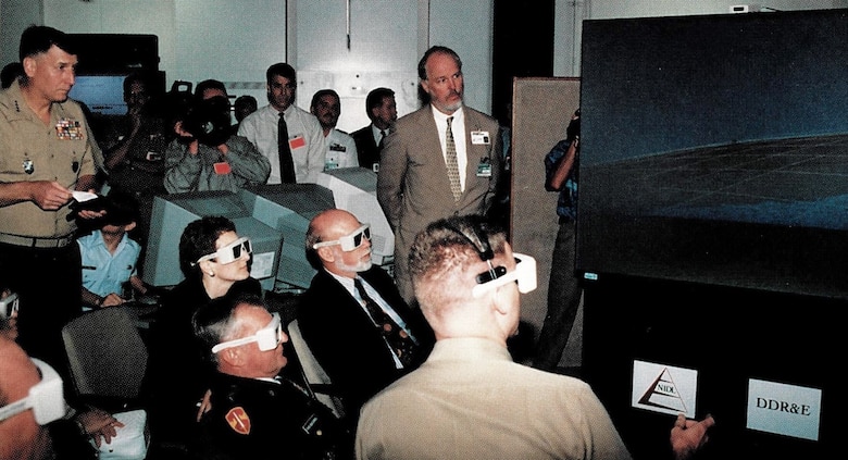 Viewing one of the 3-D displays during JWID97 execution is General Malchase D. Shalikashvili, Chairman of the Joint Chiefs of Staff and General John J. Sheehan, Supreme Allied Command Atlantic, NATO, 1997. 
(Courtesy of the Mr. Thomas P. Korte)