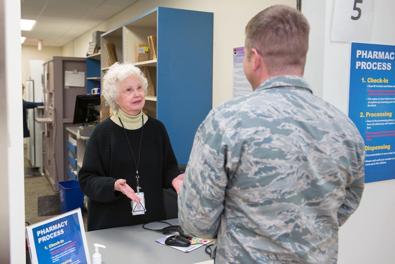 A 55th Medical Group Red Cross volunteer, speaks to a serivce member in the Ehrling Burquist pharmacy Jan. 7, 2019, Offutt Air Force Base, Nebraska. The base pharmacy carefully screens all medications to ensure quality controlled products are correctly supplied to their patients. (U.S. Air Force photo by Zachary Hada)