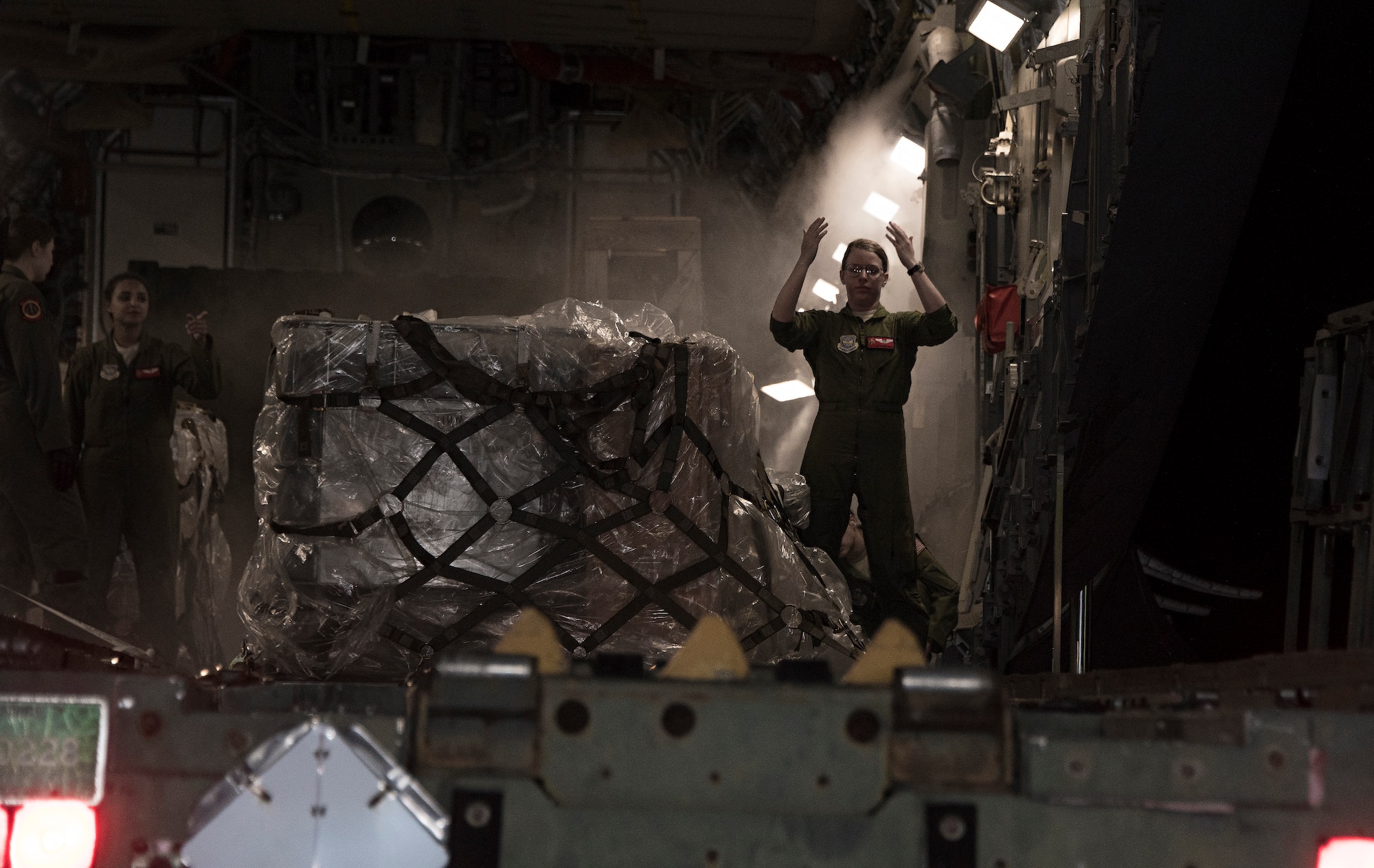 a loadmaster, marshals a tunner loader into position