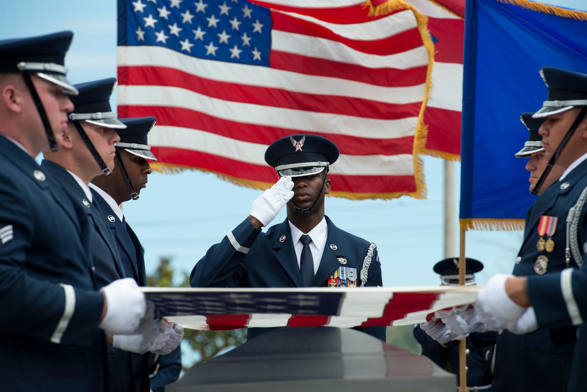 Airmen assigned to the U.S. Air Force Honor Guard fold an American flag