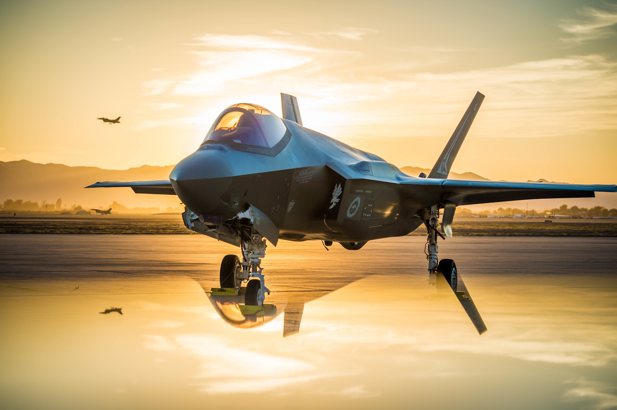 The sun sets behind an Australian F-35A Lighting II