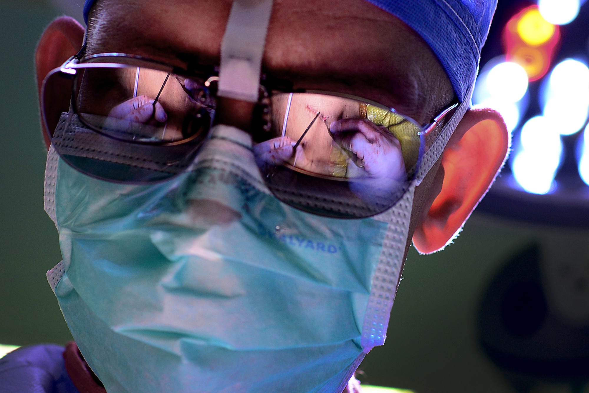 Major Richard Knight, diplomate of the American Board of Urology and 48th Medical Group chief of surgery, makes the final sutures on a patient during a laparoscopic radical prostatectomy surgery