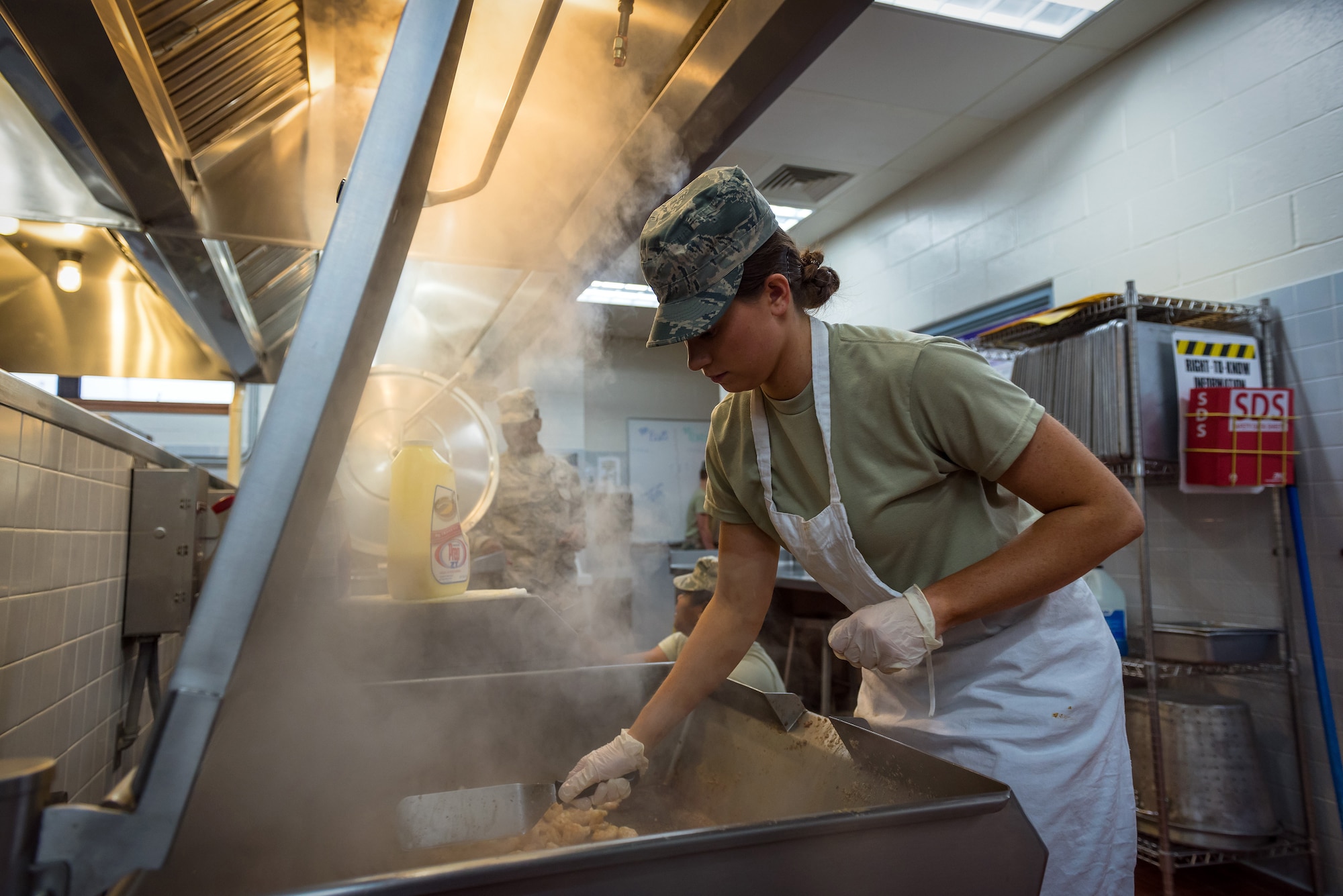 Katelyn Morris, a services specialist with the 182nd Force Support Squadron, Illinois Air National Guard, cooks shrimp