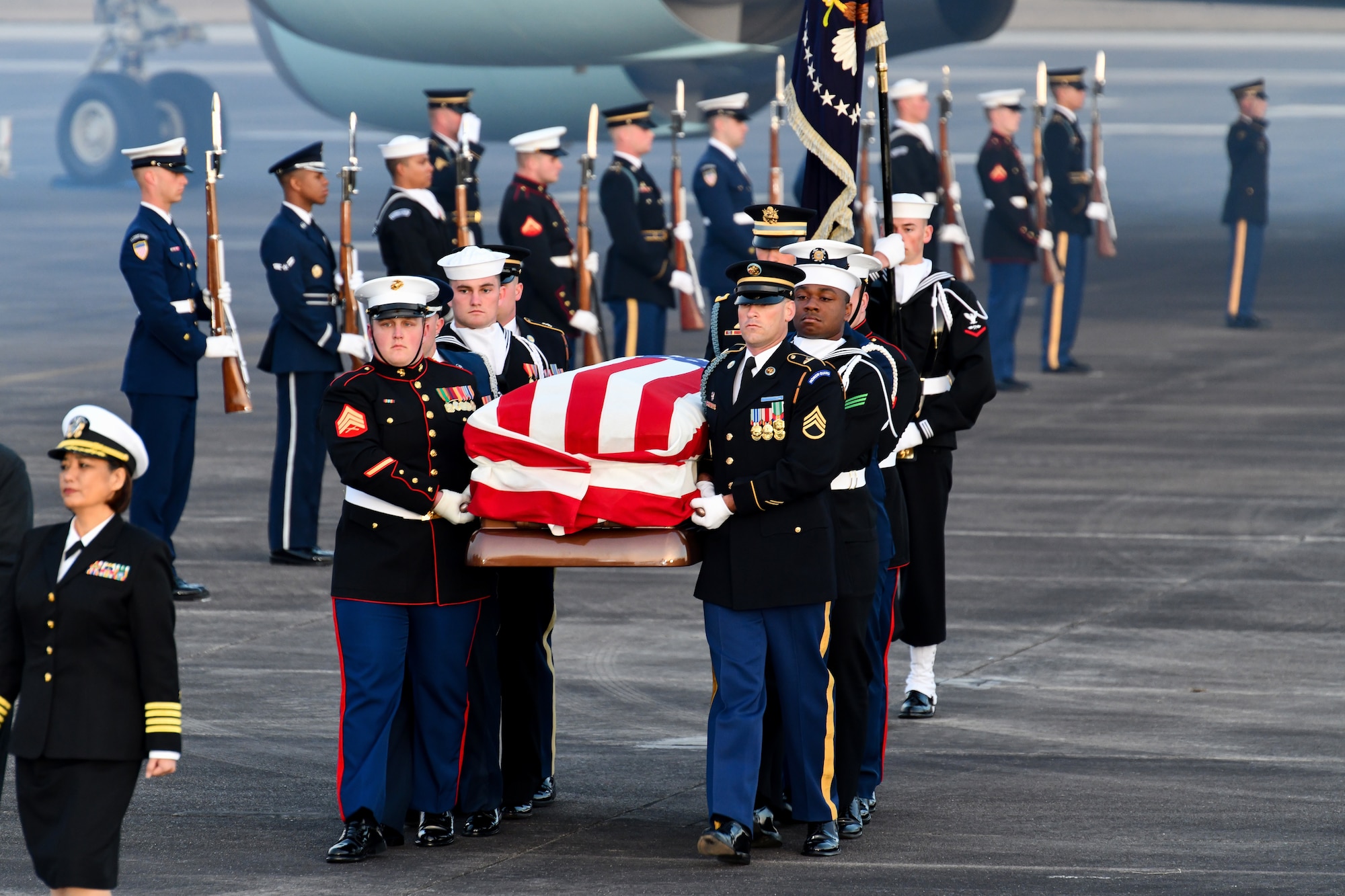 Service members of the joint forces honor guard provide military honors during the arrival of former President George H. W. Bush