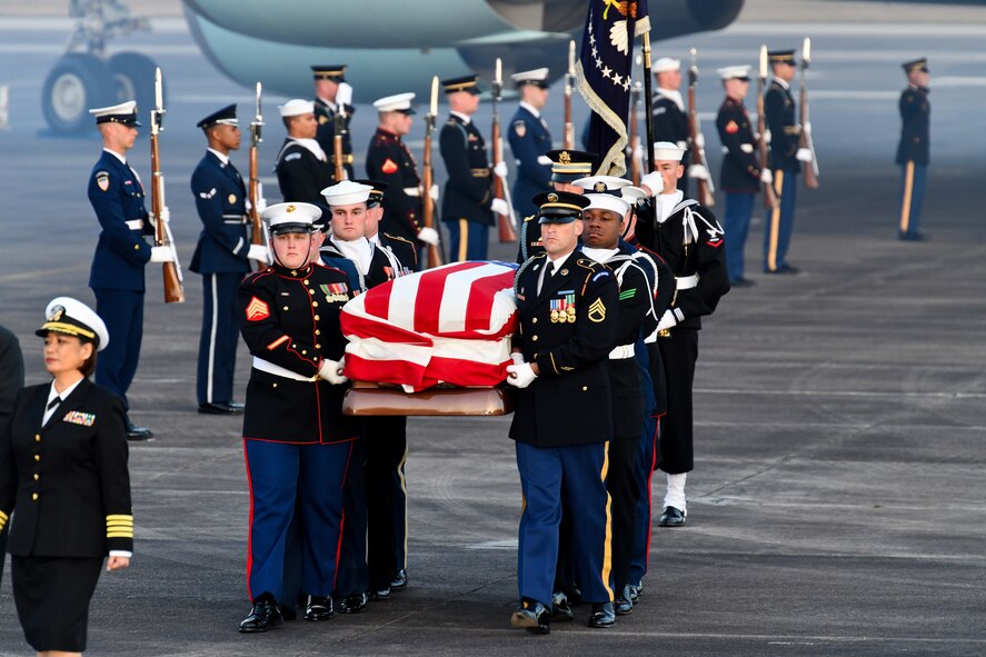 Service members of the joint forces honor guard provide military honors during the arrival of former President George H. W. Bush