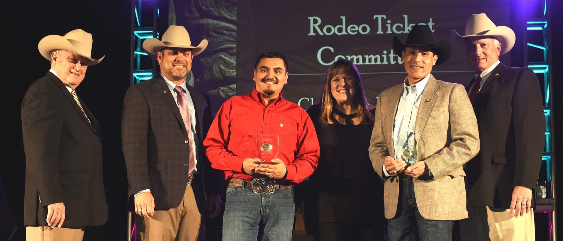 (From left) San Antonio Stock Show & Rodeo Chairman of the Board Joe Soules; Executive Director and CEO Cody Davenport; Director of Military Affairs for Texas A&M University-San Antonio Richard Delgado Jr.; Rodeo Ticket Committee Chairwoman Kelly Ross; Lt. Cmdr. Markel Zatarain of Navy Recruiting District San Antonio; and Rodeo President Rusty Collier pose for photos after Delgado and Zatarain were recognized as Outstanding Committeemen and Volunteers of the Year for 2017-2018 during the San Antonio Stock Show & Rodeo Hall of Fame Induction and Awards Ceremony held at the Freeman Expo Hall.