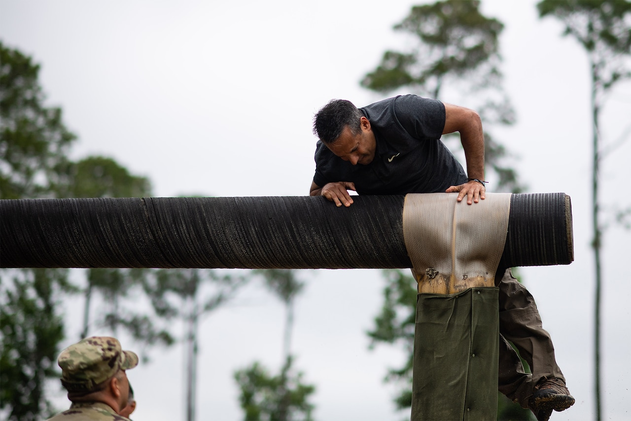 A civilian completes an obstacle course