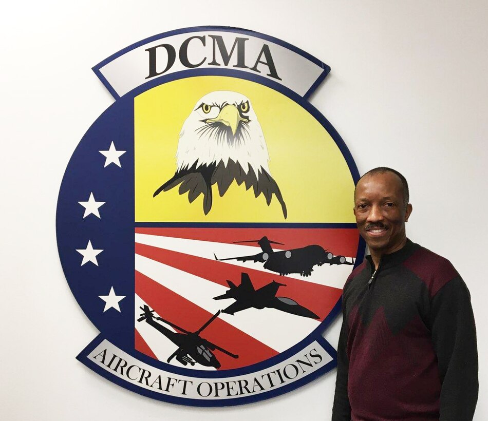 Man standing beside a DCMA sign
