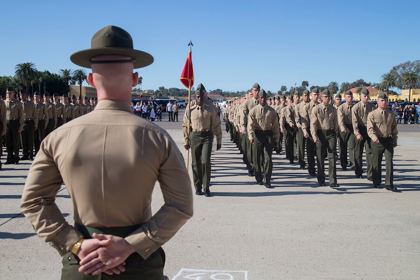 Marines march in rows during training.