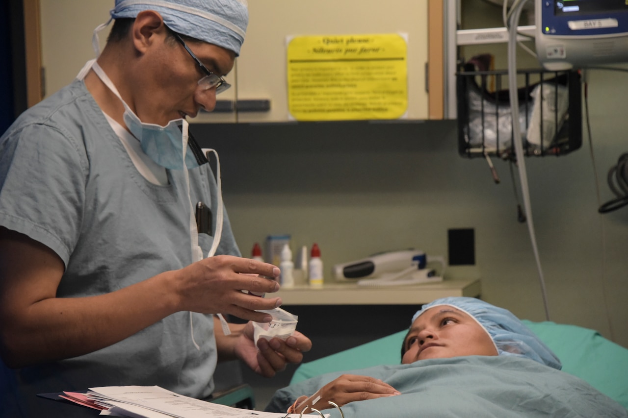 A U.S. military doctor discusses operation procedure with patient.