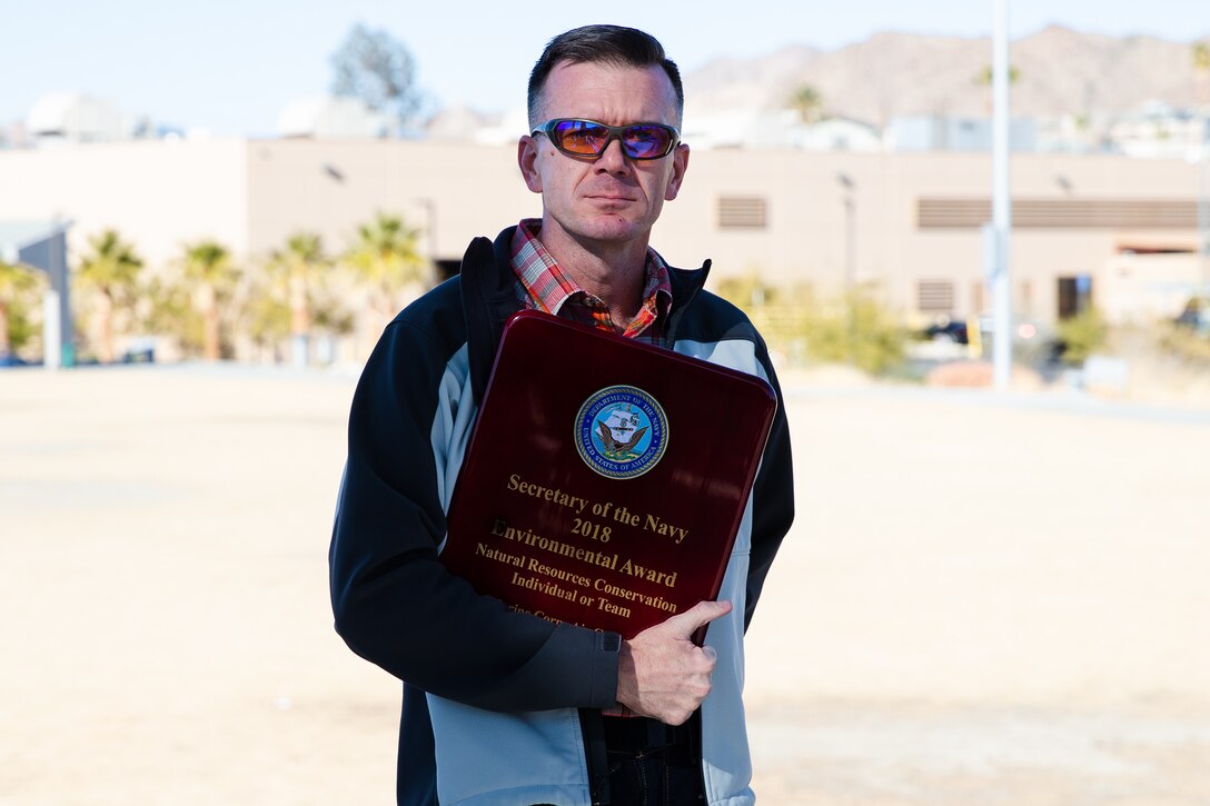 Walter Christianson poses for a photo during an award ceremony at the Victory Field Amphitheater on MCAGCC, Calif., Jan. 10, 2019. Three awards were given for environmental quality, environmental restoration, and natural resources conservation team or individual.   (U.S. Marine Corps photo by Lance Cpl. Colton Brownlee)