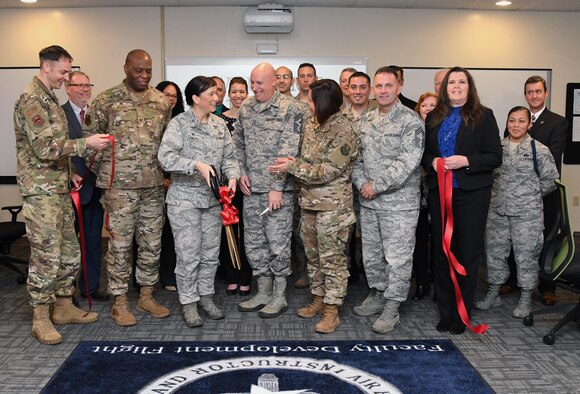 Keesler leadership participates in the Student-Centered Active Learning Environment with Upside-down Pedagogies ribbon cutting ceremony inside Allee Hall at Keesler Air Force Base, Mississippi, Jan. 10, 2019. The SCALE-UP program was introduced by the 81st Training Support Squadron as a way to bring new technology and teaching techniques into Keesler classrooms to put more focus on students and their success in Air Force education. The new program has also brought a new way to teach basic skills like time management and critical thinking to the students while learning their career field. (U.S. Air Force photo by Kemberly Groue)