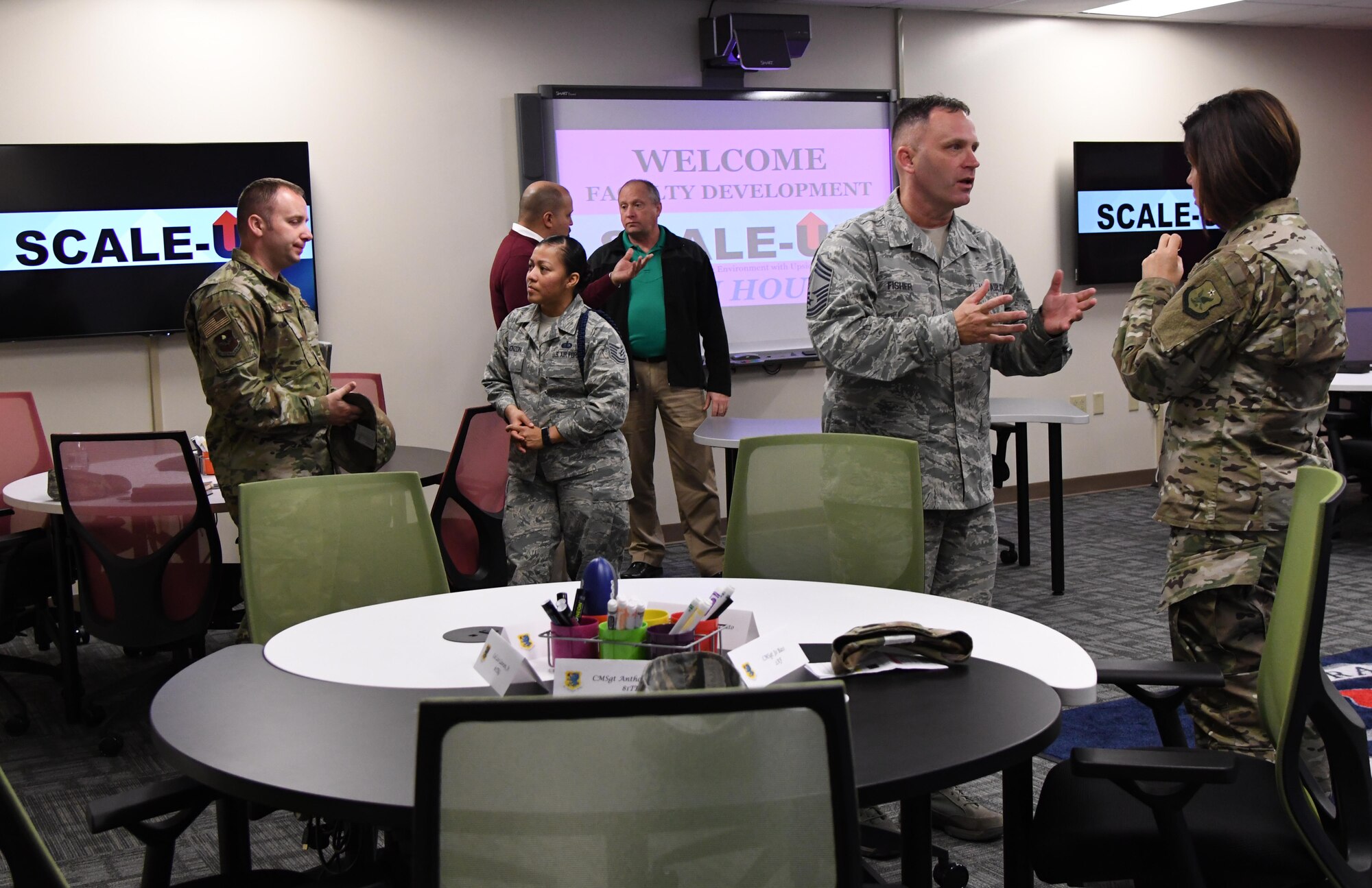 Keesler leadership and base personnel tour a classroom during the Student-Centered Active Learning Environment with Upside-down Pedagogies ribbon cutting ceremony inside Allee Hall at Keesler Air Force Base, Mississippi, Jan. 10, 2019. The SCALE-UP program was introduced by the 81st Training Support Squadron as a way to bring new technology and teaching techniques into Keesler classrooms to put more focus on students and their success in Air Force education. The new program has also brought a new way to teach basic skills like time management and critical thinking to the students while learning their career field. (U.S. Air Force photo by Kemberly Groue)