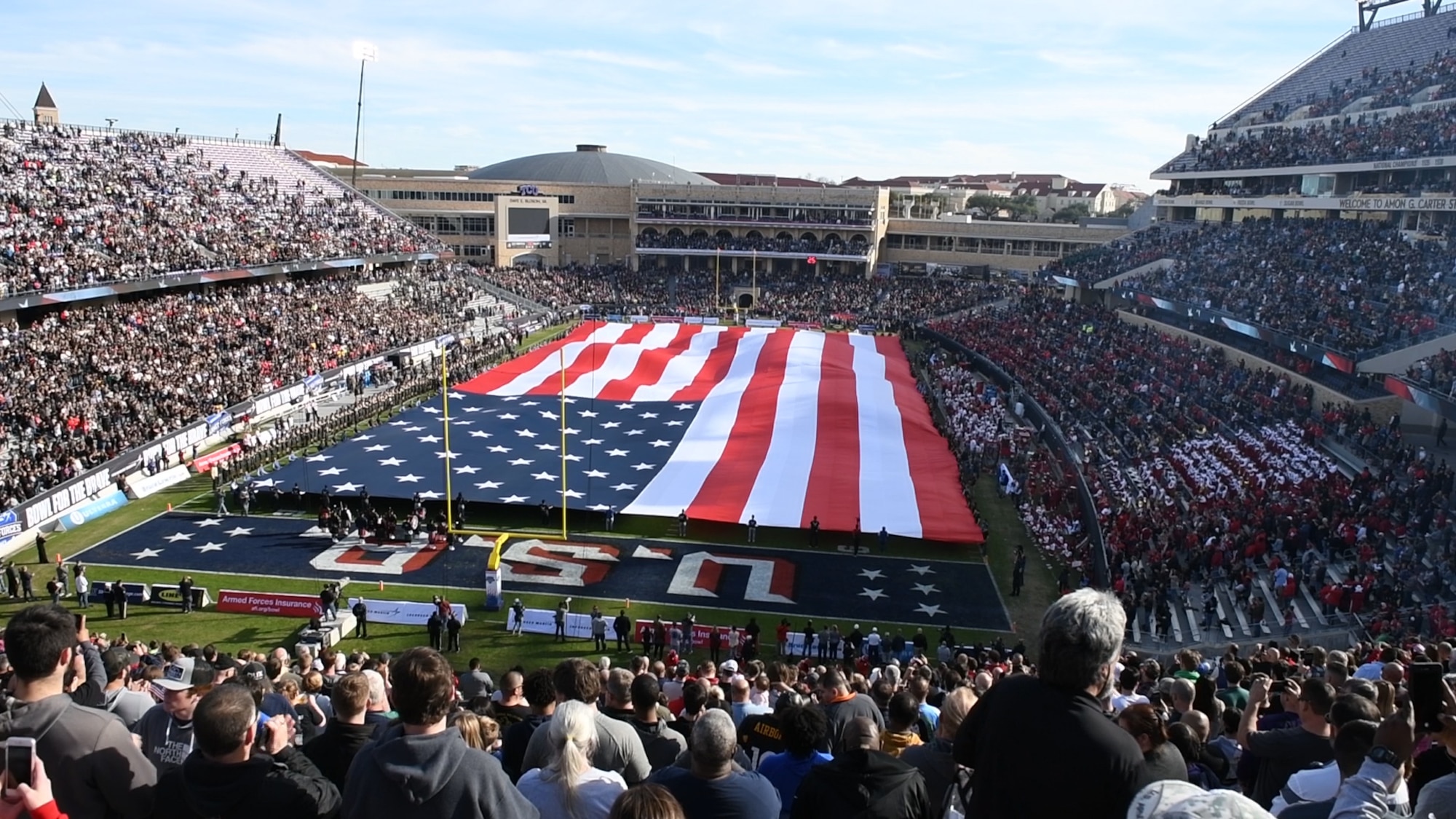 Volunteers unfold the American flag before the Armed Forces Bowl, Dec. 22, 2018, at Fort Worth, Texas. The flag was unfolded during the playing of the national anthem to honor every branch of the U.S. military. (U.S. Air Force photo by Amn Dallin Wrye)