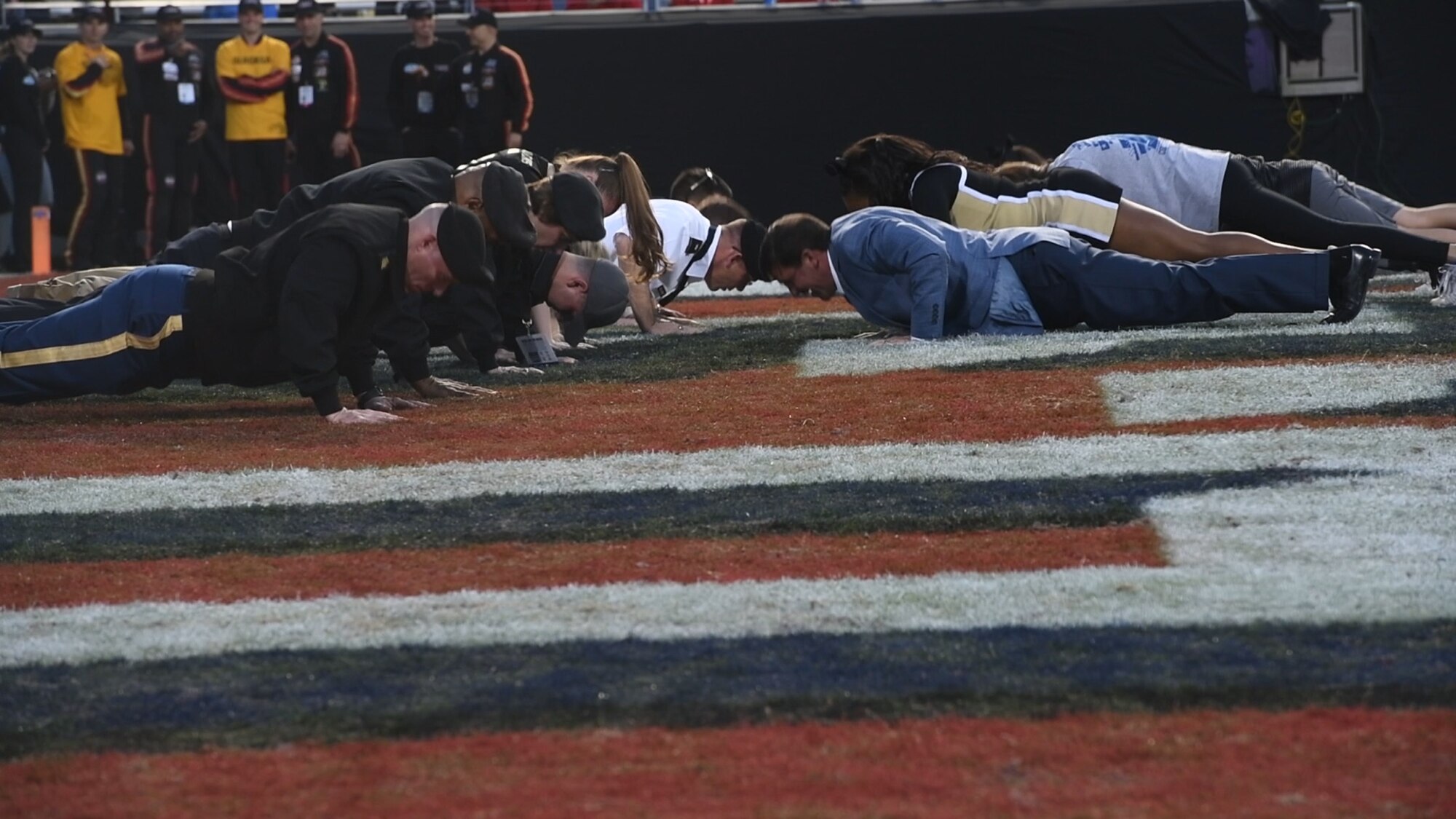 U.S. Army Soldiers perform push-ups after the Army scores, Dec. 22, 2018, at Fort Worth, Texas. The Army team scored 70 points during the Armed Forces Bowl.