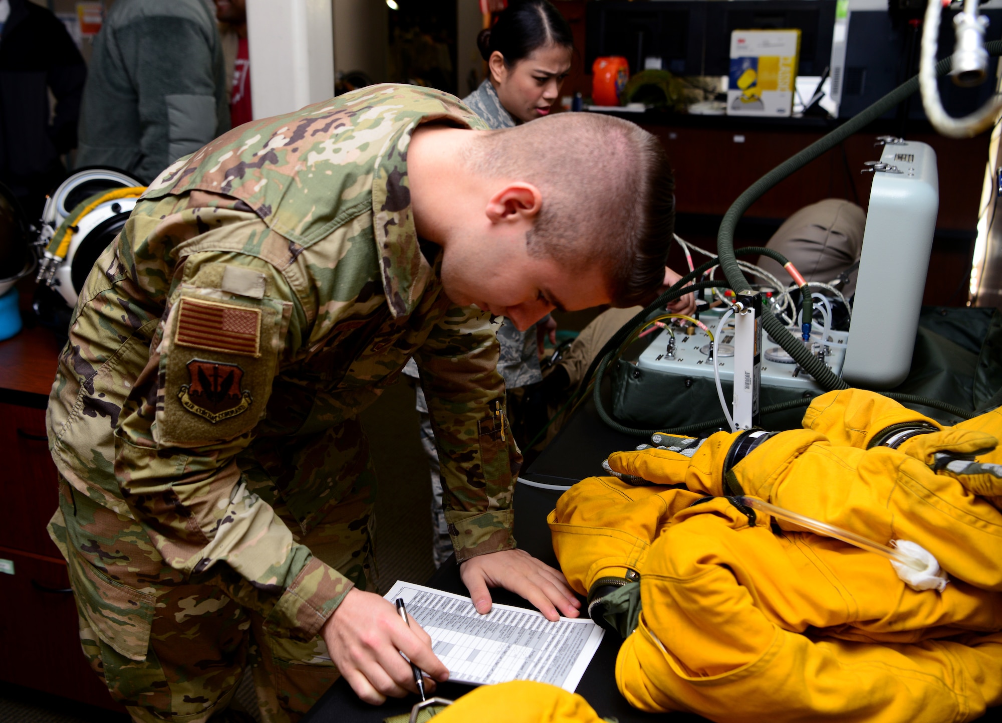 Senior Airman Jonathan Branson, 9th Physiological Support Squadron launch and recovery technician, completes preflight paperwork