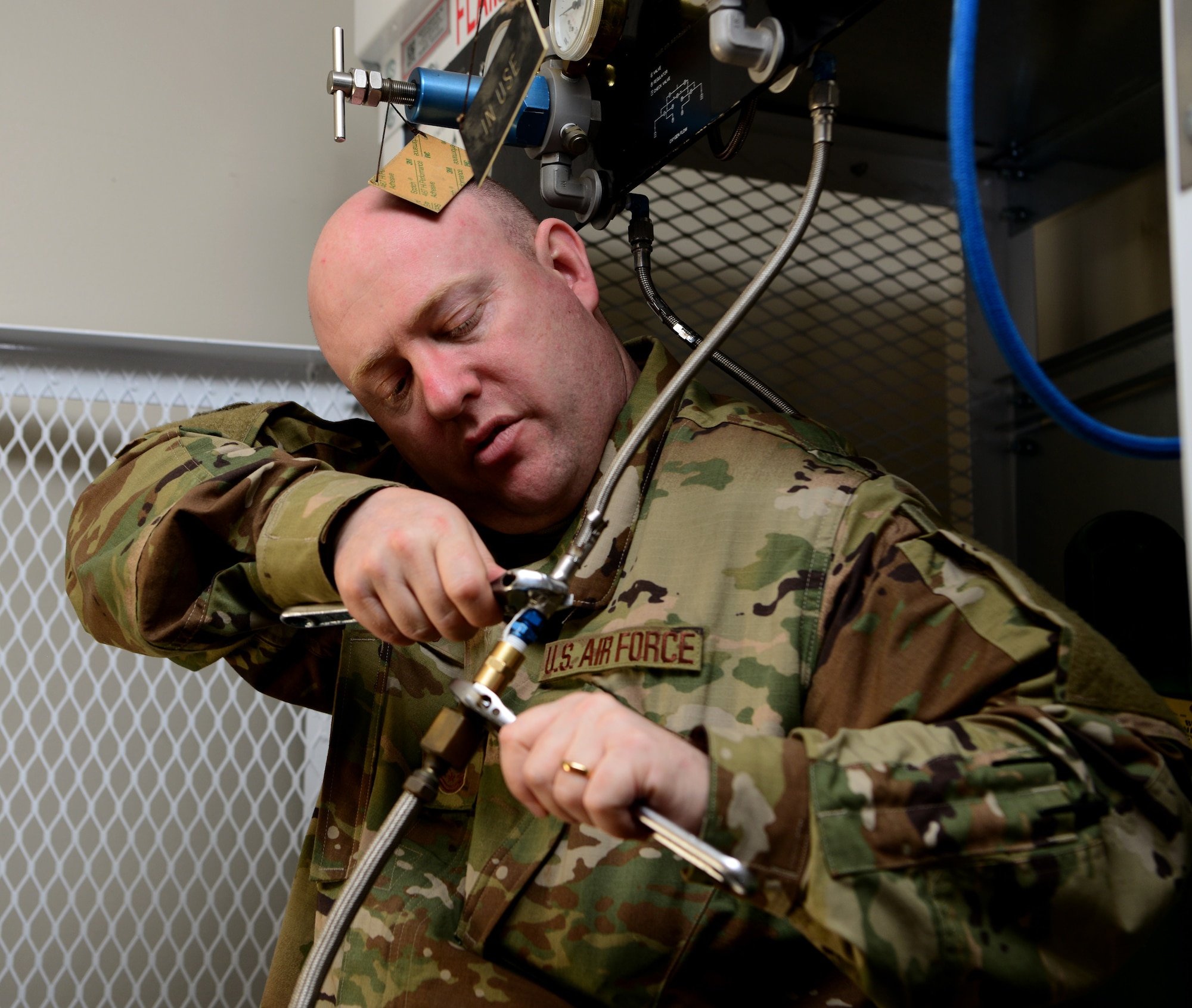 Master Sgt. Charles Myers, 9th Physiological Support Squadron flight chief, sets up a system to deliver oxygen to U-2 Dragon Lady pilots in a temporary staging