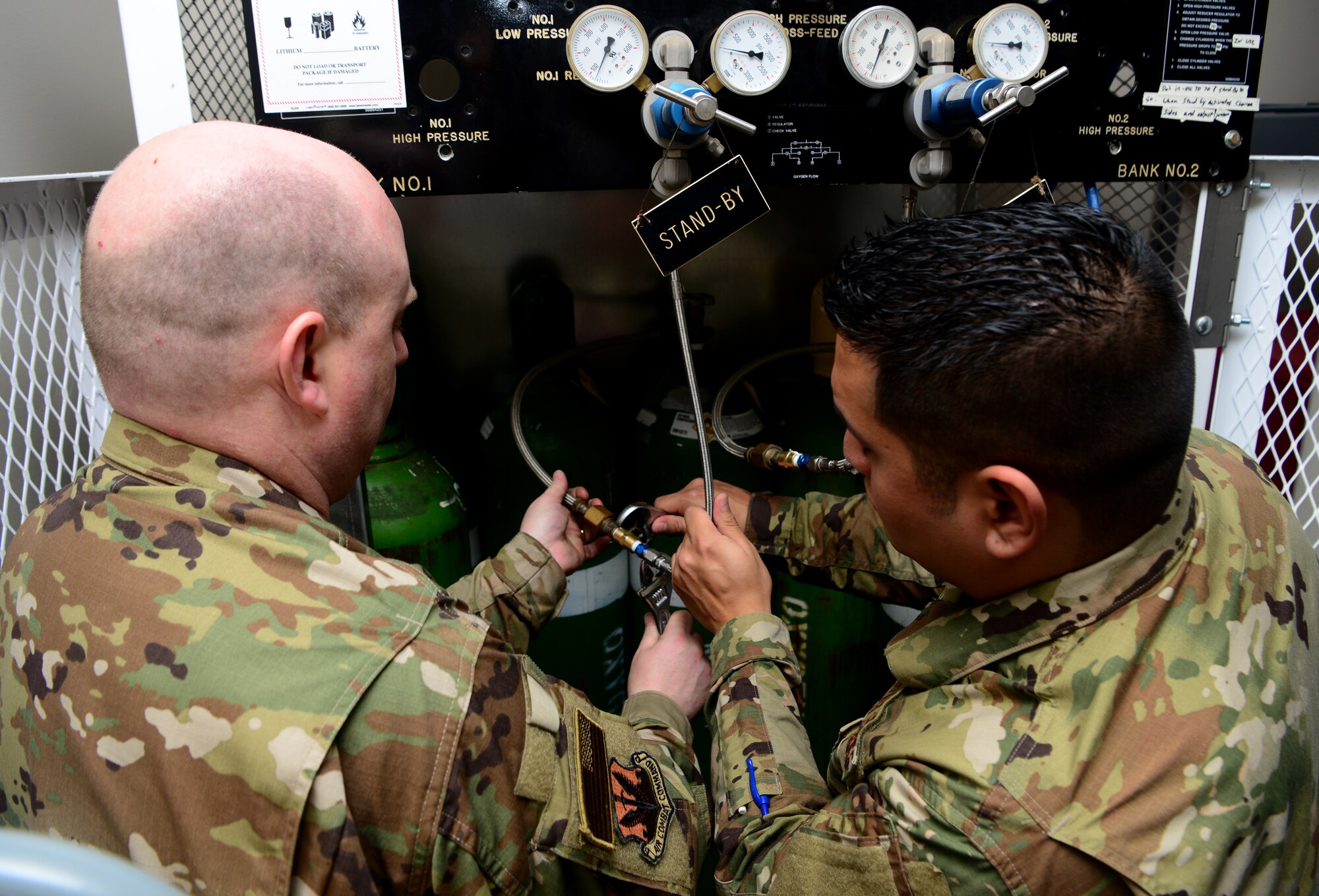 Master Sgt. Charles Myers (left), 9th Physiological Support Squadron flight chief, and Tech. Sgt. Fernando Ramirez, launch and recover non-commissioned officer in charge, set up a system to deliver oxygen to U-2 Dragon Lady