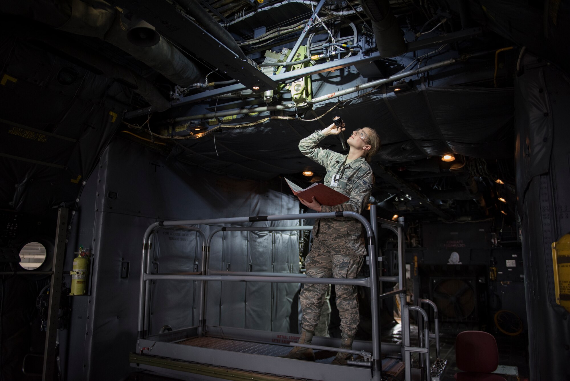 An Airman inspects a booster pack for damage on a C-130 Hercules