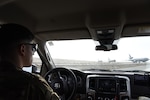 Airman Jesse Meraz, 380th EOSS airfield management operations coordinator, watches as KC-10s taxi down the runway, Jan. 8, 2019 at Al Dhafra Air Base, United Arab Emirates.