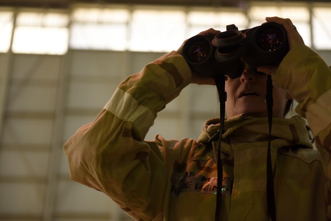 U.S. Air Force 145th Comptroller Flight Commander, Maj. Jeanie Helms, practices identifying explosive ordinance devices from a distance during an Ability To Survive and Operate (ATSO) training held in a C-17 Globemaster III hangar at the North Carolina Air National Guard (NCANG) Base, Charlotte Douglas International Airport, Jan. 10, 2019. The ATSO exercise consists of ten rotating stations and serves as refresher training for situations like self-aid buddy care, explosive ordinance device recognition, and chemical warfare decontamination stations.