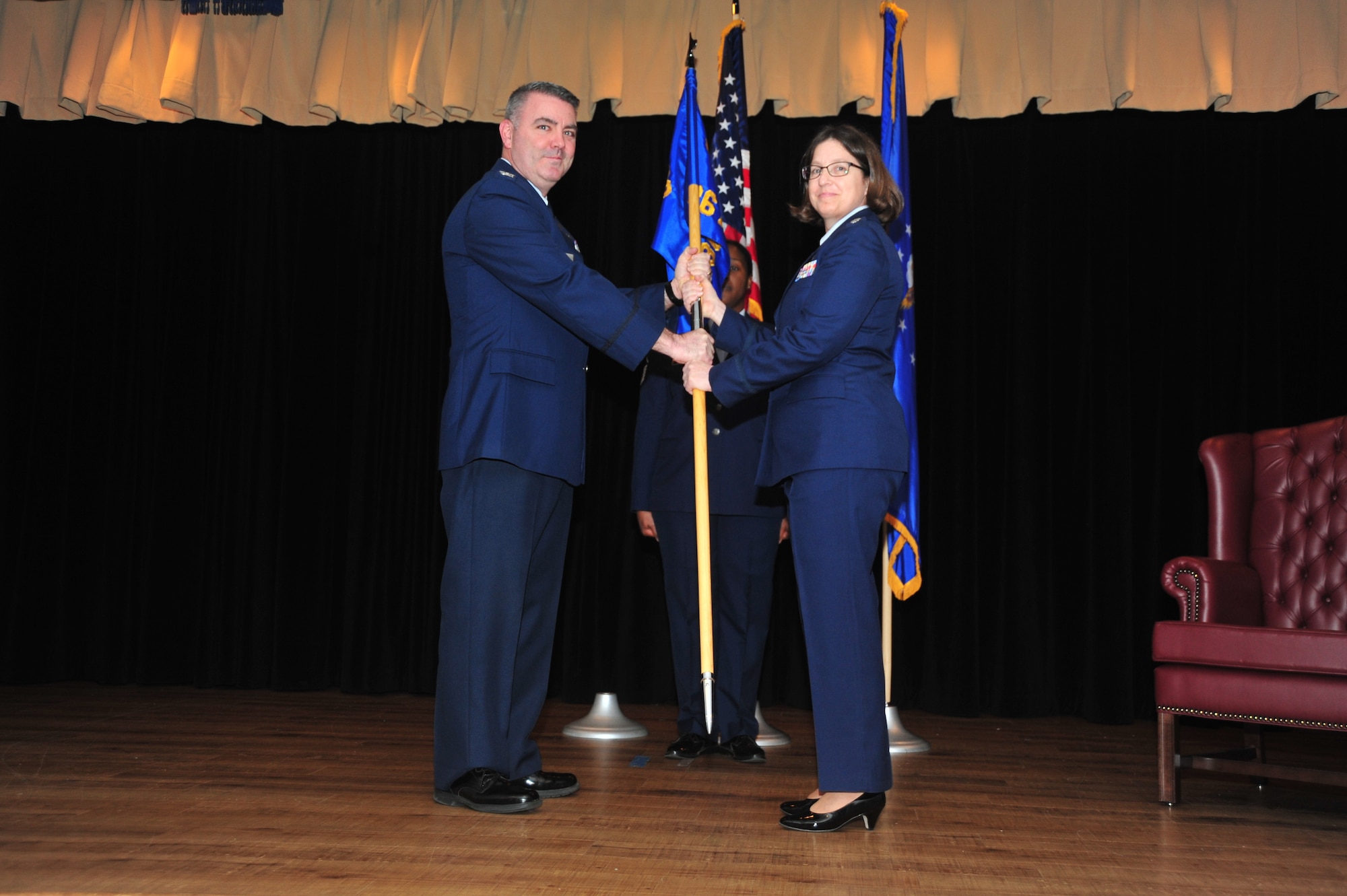 Col. Brian A. May, 403rd Operations Group commander, presents the guidon of the 36th Aeormedical Evacuation Squadron to Lt. Col. Deborah S. Deja as she assumes command during a passing of the flag ceremony held in the Keesler Medical Center at Keesler Air Force Base, Mississippi, January 13, 2019.  (U.S. Air Force photo by Tech. Sgt. Michael Farrar)