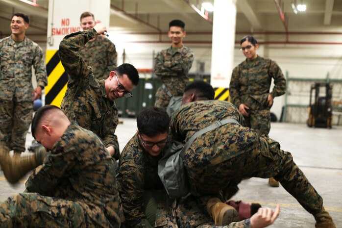 Marines with 3rd Marine Logistics Group attempt to use an Antidote Treatment Nerve Agent Autoinjector (ATNAA) on a Marine exposed to a simulated chemical agent Jan. 11, 2019 at Camp Kinser, Okinawa, Japan. For instructional purposes, Marines practiced administering antidotes to simulated combatants affected by chemical, biological, radiological and nuclear (CBRN) agents. The ATNAA was designed to help Marines who have been exposed to CBRN agents. Marines trained in reconnaissance, surveillance and decontamination (RS&D) are required to take a refresher course every fiscal quarter to ensure they are capable of performing RS&D tasks operationally. (U.S. Marine Corps photo by Lance Cpl. Mark Fike)