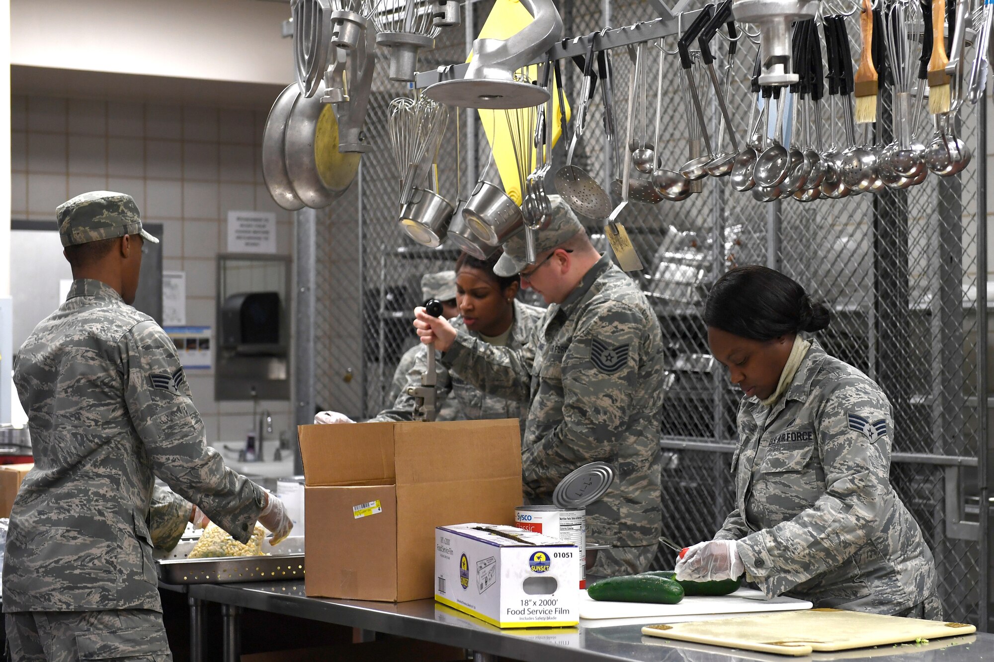 Members from both the North Carolina Air National Guard and Niagara Falls Air Reserve Station, New York, prepare lunch in the dining facility during drill weekend at the North Carolina Air National Guard Base, Charlotte Douglas International Airport, Jan. 12, 2019. Food services Airmen from the North Carolina Air National Guard train members from the Niagara Falls Air Reserve Station, New York, on full-service kitchen operations in preparation for the upcoming Air Force active duty and reserve Hennessy Award competition.