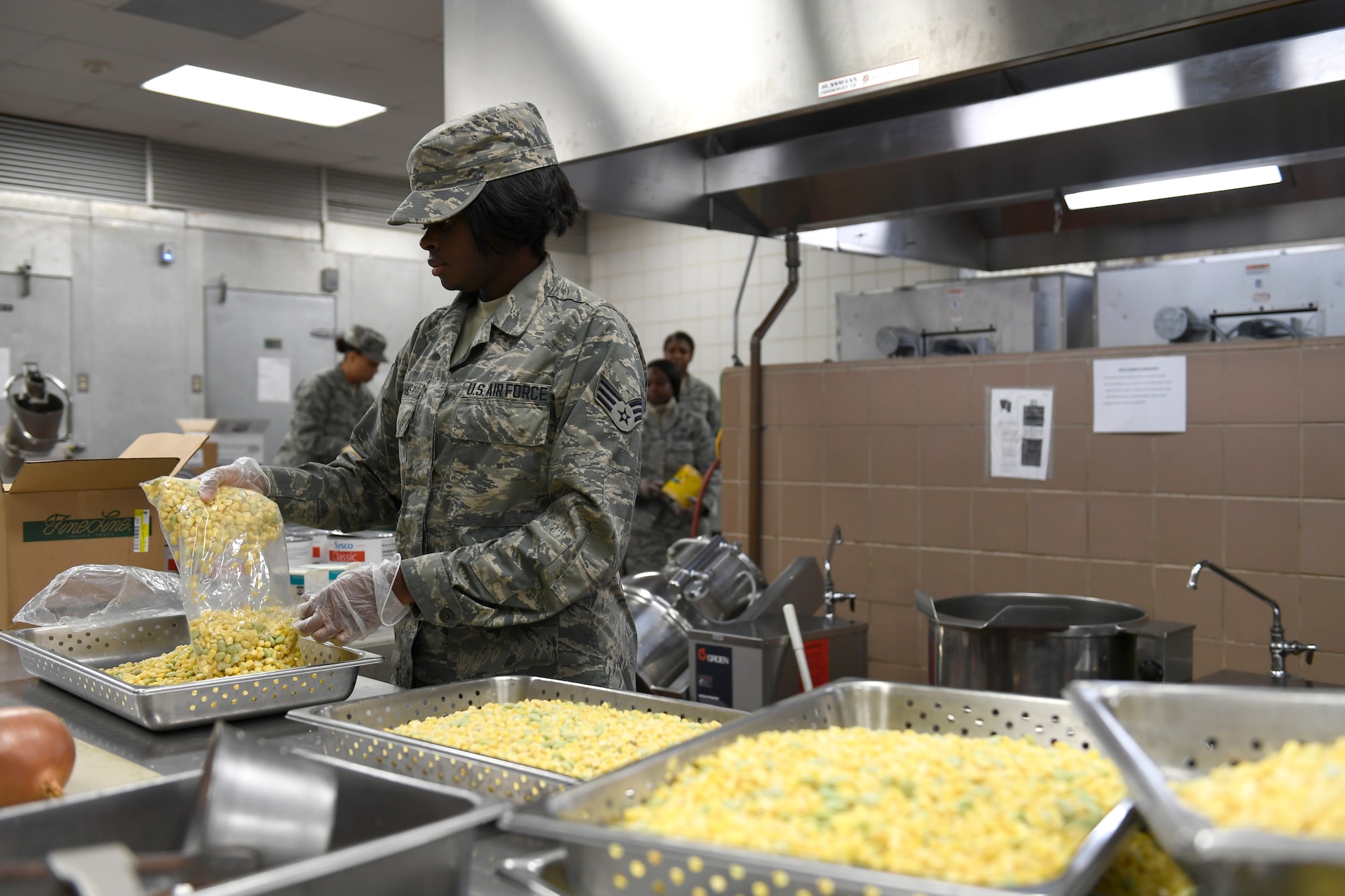 U.S. Air Force Senior Airman Lisa Banks, 145th Force Support Squadron, unpacks corn in preparation for lunch in the dining facility during drill weekend at the North Carolina Air National Guard Base, Charlotte Douglas International Airport, Jan. 12, 2019. Food services Airmen from the North Carolina Air National Guard train members from the Niagara Falls Air Reserve Station, New York, on full-service kitchen operations in preparation for the upcoming Air Force active duty and reserve Hennessy Award competition.