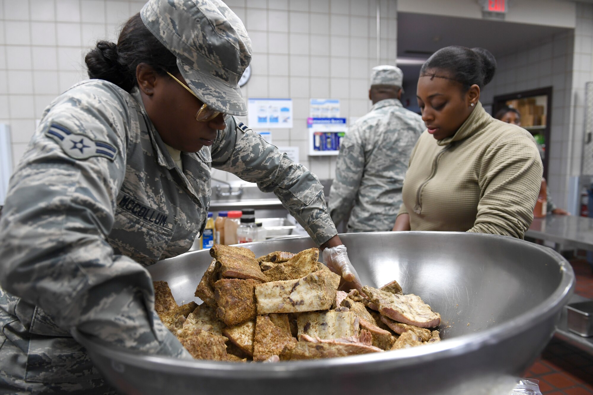 U.S. Air Force Airman 1st Class Pachea McCollum (left), 914th Air Refueling Wing, prepares lunch in the dining facility during drill weekend at the North Carolina Air National Guard Base, Charlotte Douglas International Airport, Jan. 12, 2019. Food services Airmen from the North Carolina Air National Guard train members from the Niagara Falls Air Reserve Station, New York, on full-service kitchen operations in preparation for the upcoming Air Force active duty and reserve Hennessy Award competition.