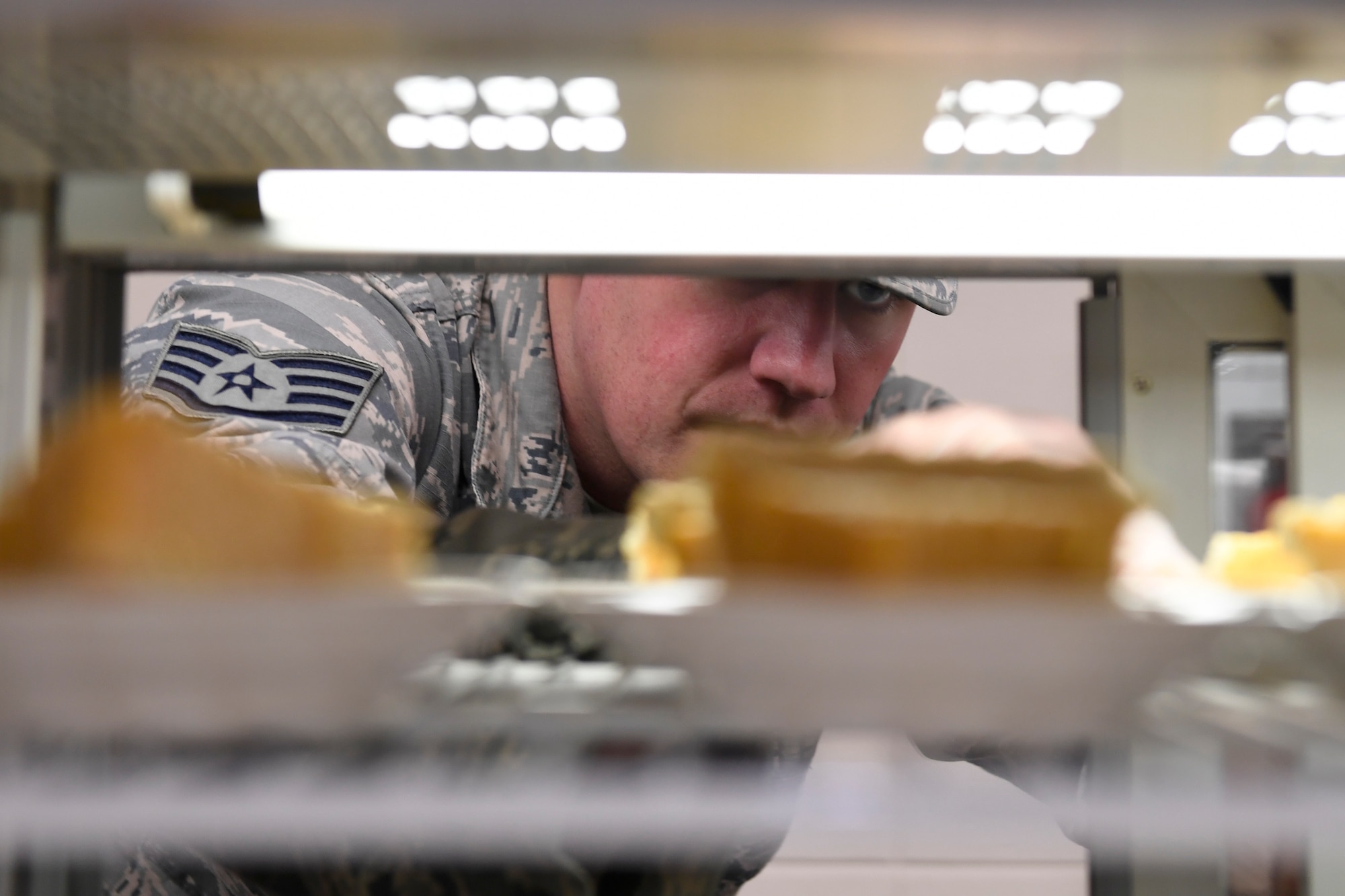 U.S. Air Force Staff Sgt. Jackson Hunt, 145th Force Support Squadron, places pumpkin pies in the display case for lunch in the dining facility during drill weekend at the North Carolina Air National Guard Base, Charlotte Douglas International Airport, Jan. 12, 2019. Food services Airmen from the North Carolina Air National Guard train members from the Niagara Falls Air Reserve Station, New York, on full-service kitchen operations in preparation for the upcoming Air Force active duty and reserve Hennessy Award competition.