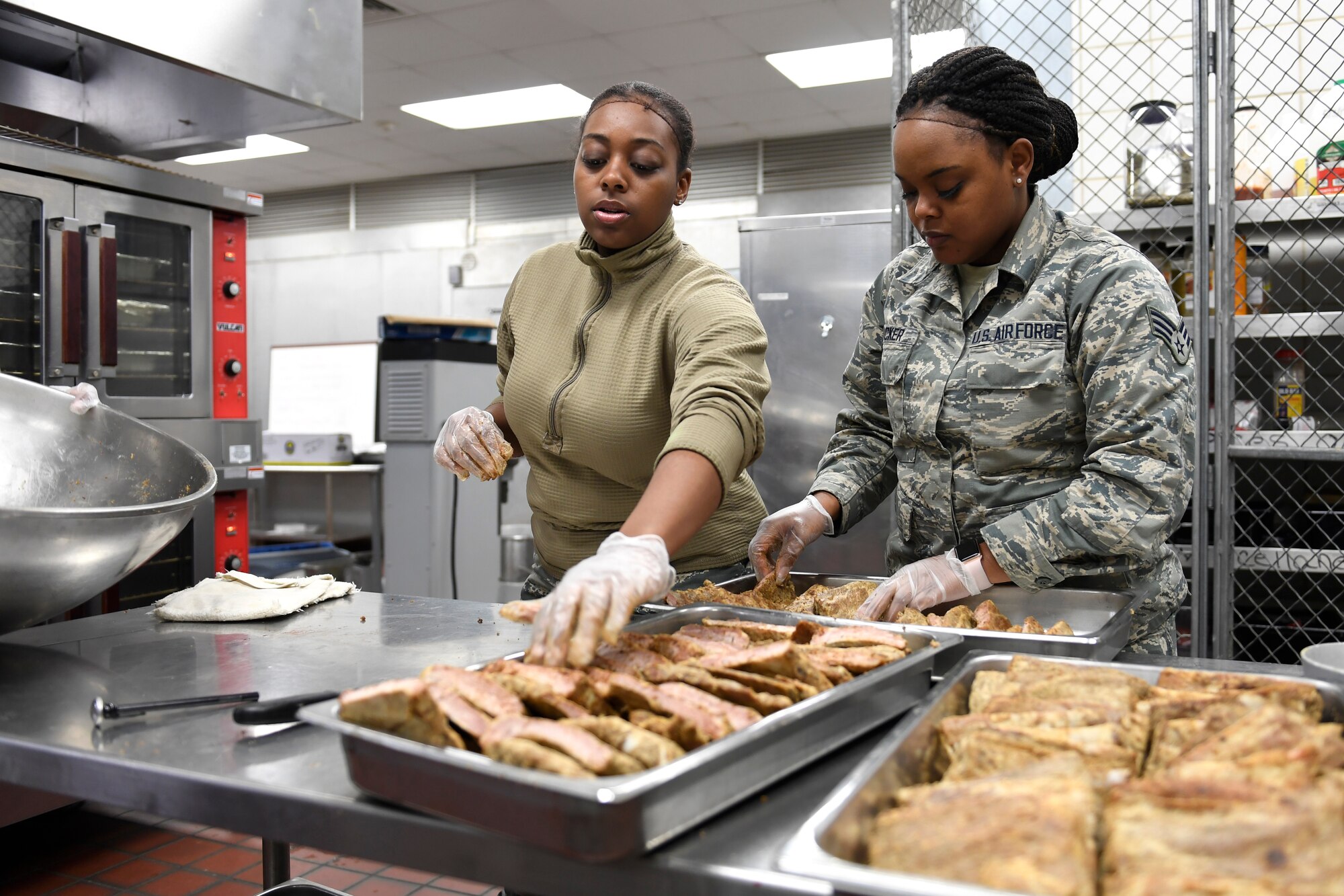 Members from both the North Carolina Air National Guard and Niagara Falls Air Reserve Station, New York, prepare lunch in the dining facility during drill weekend at the North Carolina Air National Guard Base, Charlotte Douglas International Airport, Jan. 12, 2019. Food services Airmen from the North Carolina Air National Guard train members from the Niagara Falls Air Reserve Station, New York, on full-service kitchen operations in preparation for the upcoming Air Force active duty and reserve Hennessy Award competition.