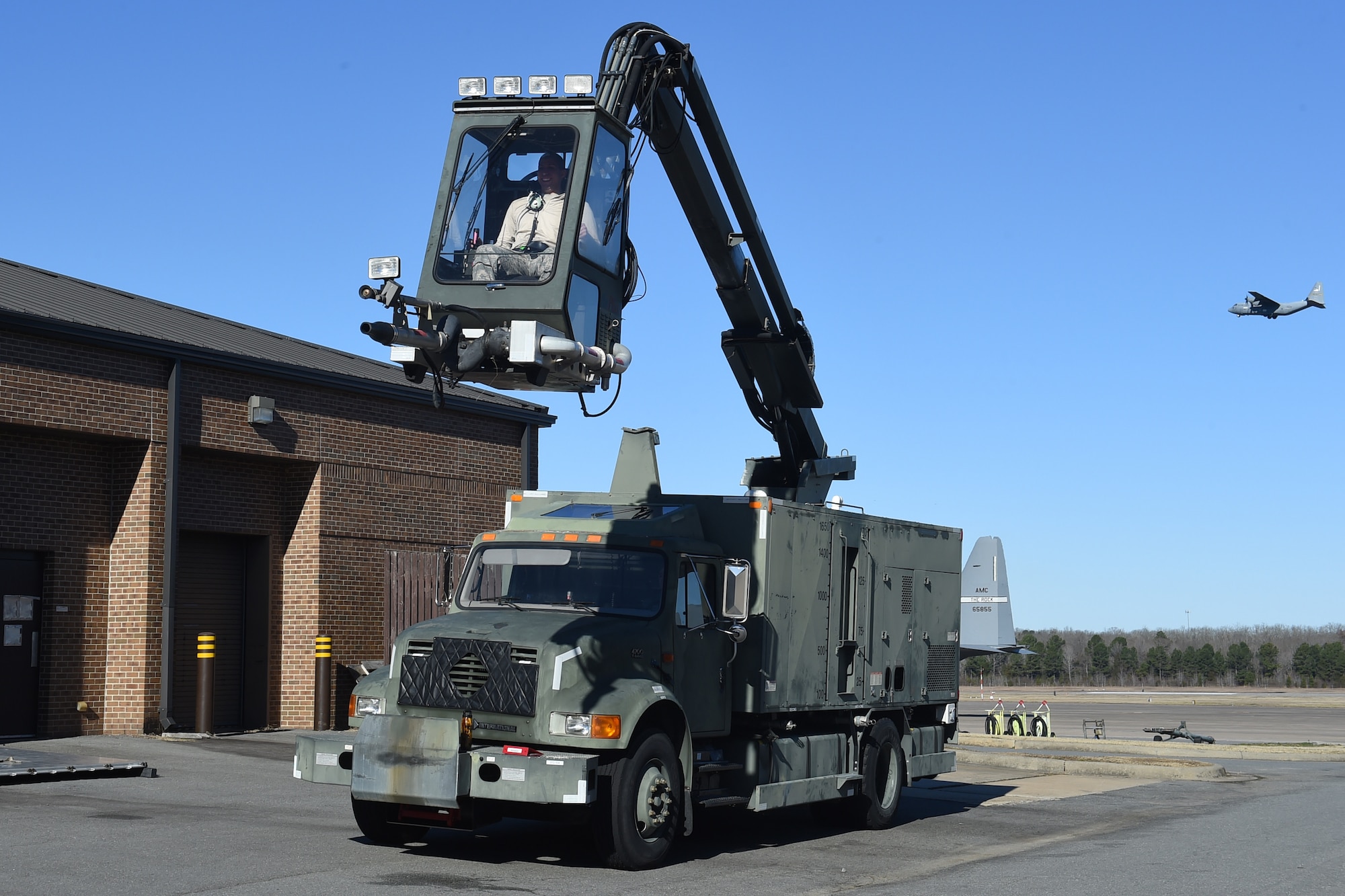 An Airmen is in a de-icing truck.