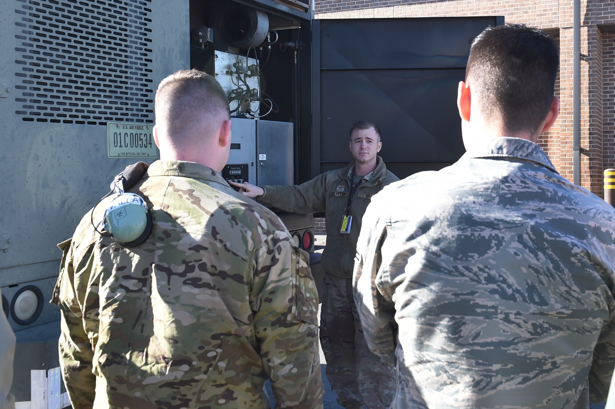 An Airman talks to two Airmen.