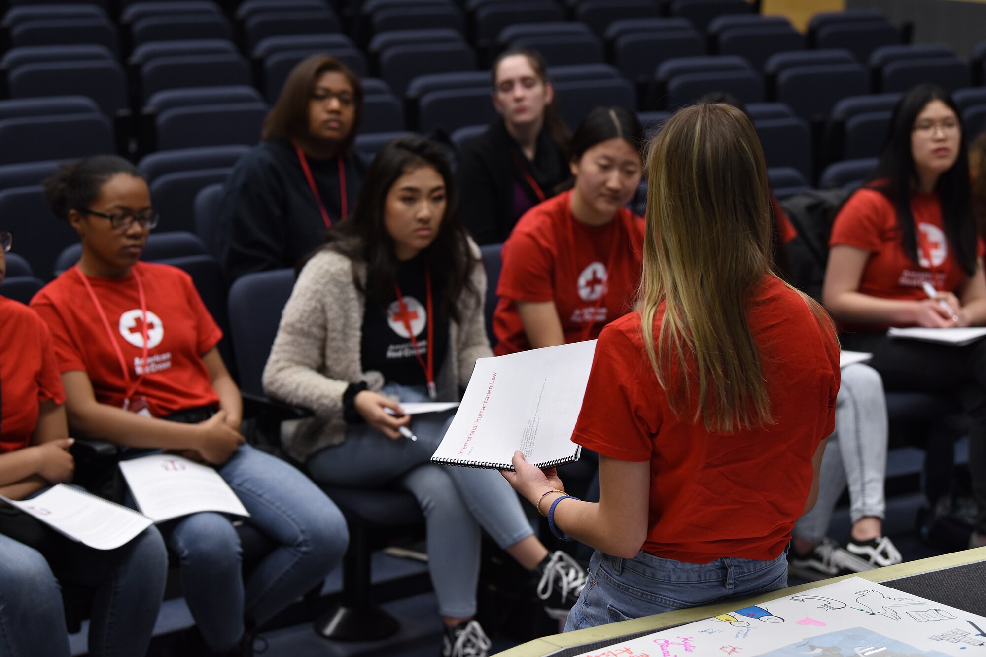 Lakenheath High School students answer questions relating to International Humanitarian Law during the IHL Youth Action Campaign at the school auditorium at Royal Air Force Lakenheath, England, Jan. 12, 2019. The lecture-based training was held on the second day, teaching students about the history of IHL and the Geneva Convention, the challenges health care workers face during armed conflicts, and how to design an IHL campaign.(U.S. Air Force photo by Airman 1st Class Madeline Herzog)