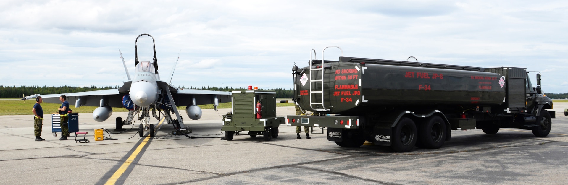 A Royal Canadian air force CF-18 Hornet sits on the Eielson Air Force Base, Alaska, flight line while a U.S. Air Force fuel truck prepares to refuel the aircraft during an exercise in Alaska. The exercise provides an optimal training environment in the Indo-Asia-Pacific Region and focuses on improving ground, space, and cyberspace combat readiness and interoperability for U.S. and international forces.