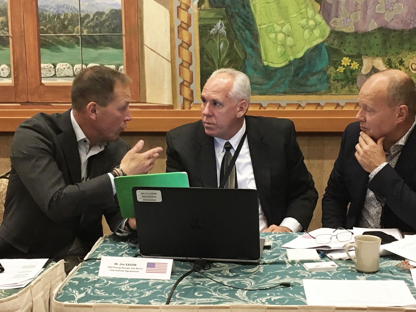 DLA Energy International Agreements Specialist Jim Eason confers with Spanish fuel representatives during the 2018 Fuel Exchange Agreement Forum in Garmisch-Partenkirchen, Germany.
