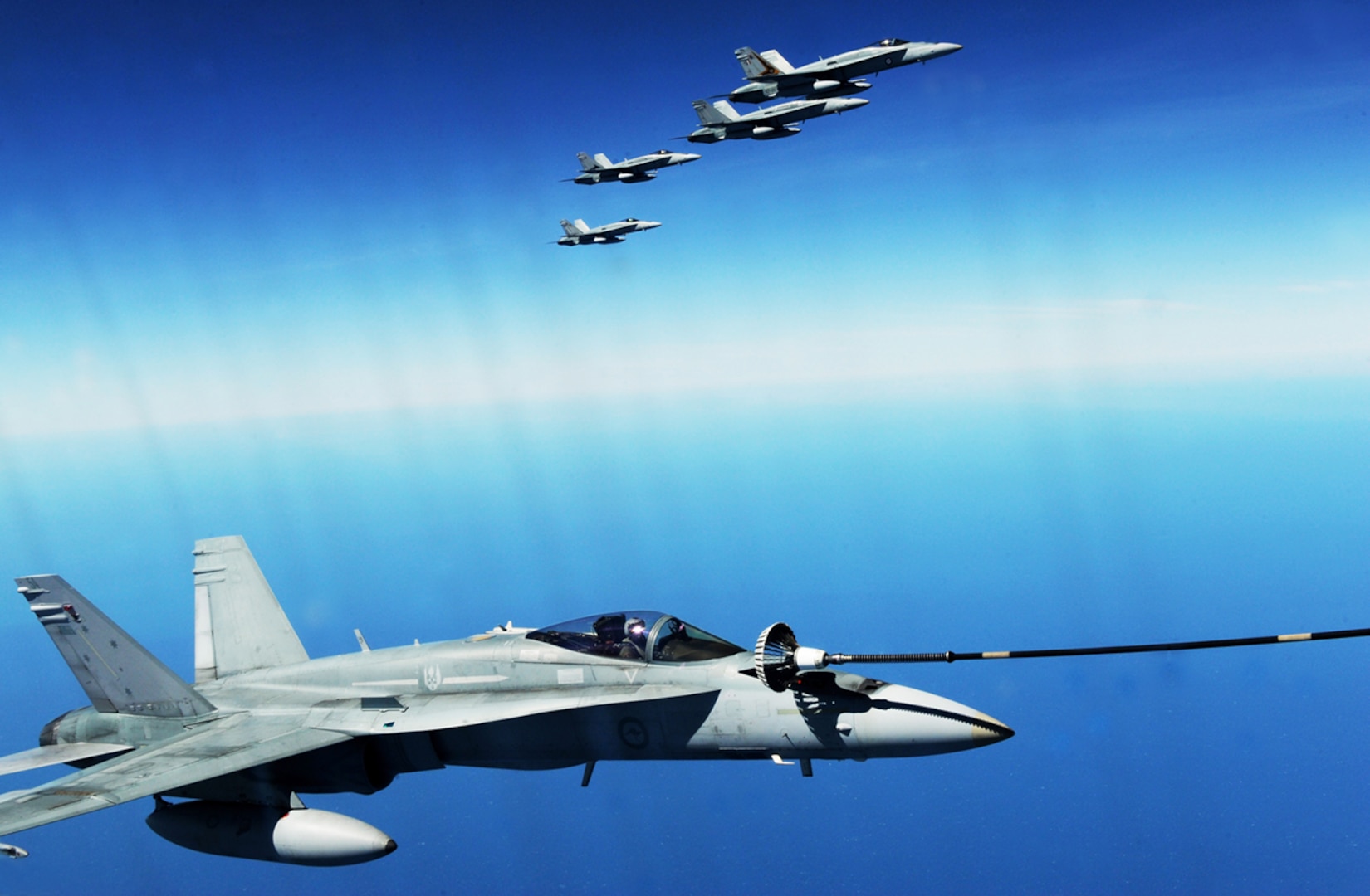 A Royal Australian air force F/A-18 Hornet refuels during a training exercise near Darwin, Australia. U.S. and Australian forces conduct air refueling missions throughout the exercise to improve interoperability and familiarization with each other’s procedures.