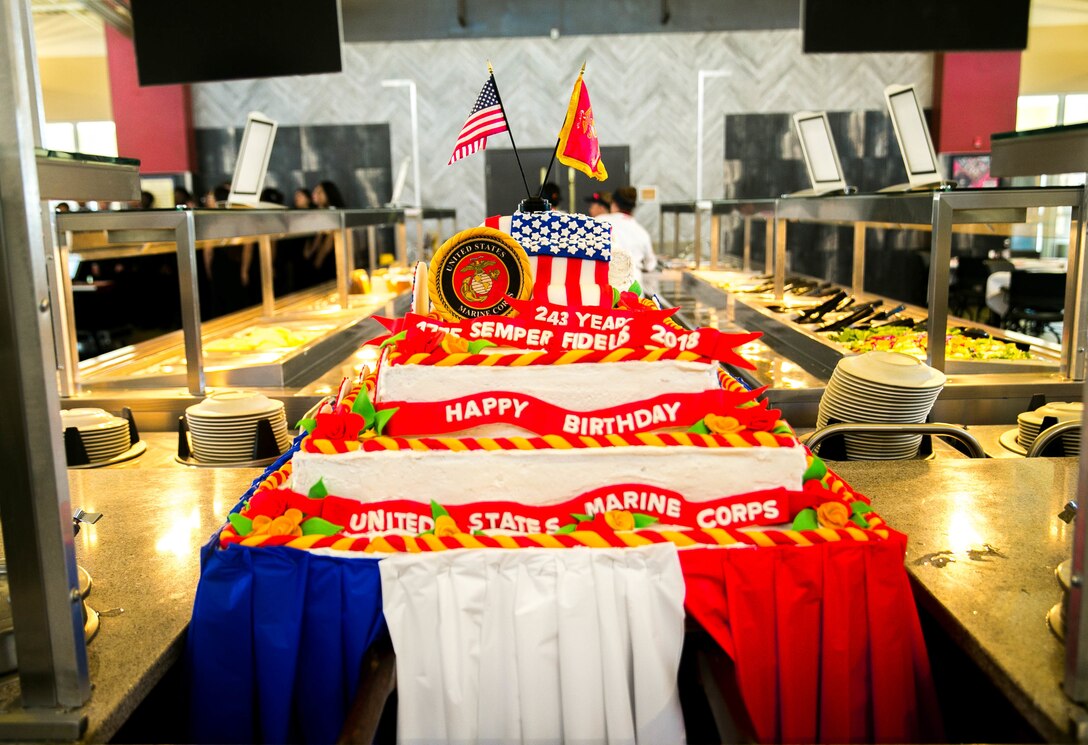 Marines and Sodexo employees prepare a traditional birthday cake for the Marine Corps' 243rd birthday lunch at Littleton Mess Hall, aboard Marine Corps Air Ground Combat Center, Twentynine Palms, Calif., Nov. 9, 2018. Sodexo works for the Marine Corps every year to provide a birthday meal for the Marines at the mess halls across the installation. (Marine Corps photo by Cpl. Ashlee Conover)