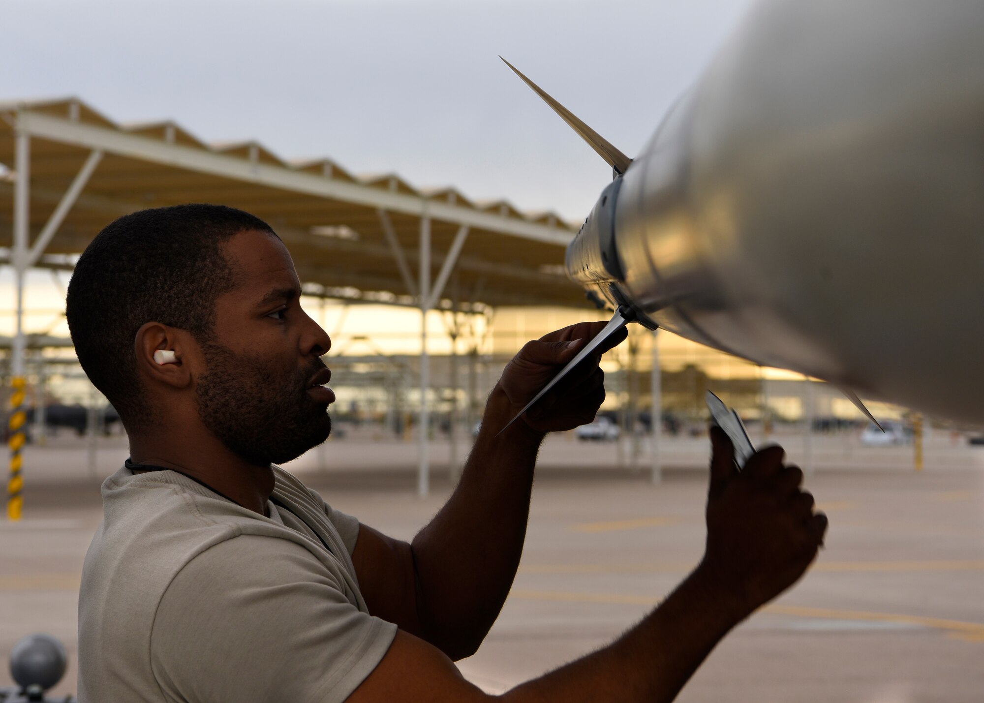 Staff Sgt. Albert Banks, 309th Aircraft Maintenance Unit load crew chief, attaches fins to an inert missile during the 56th Fighter Wing Quarterly Load Crew Competition at Luke Air Force Base, Ariz., Jan. 10, 2019.