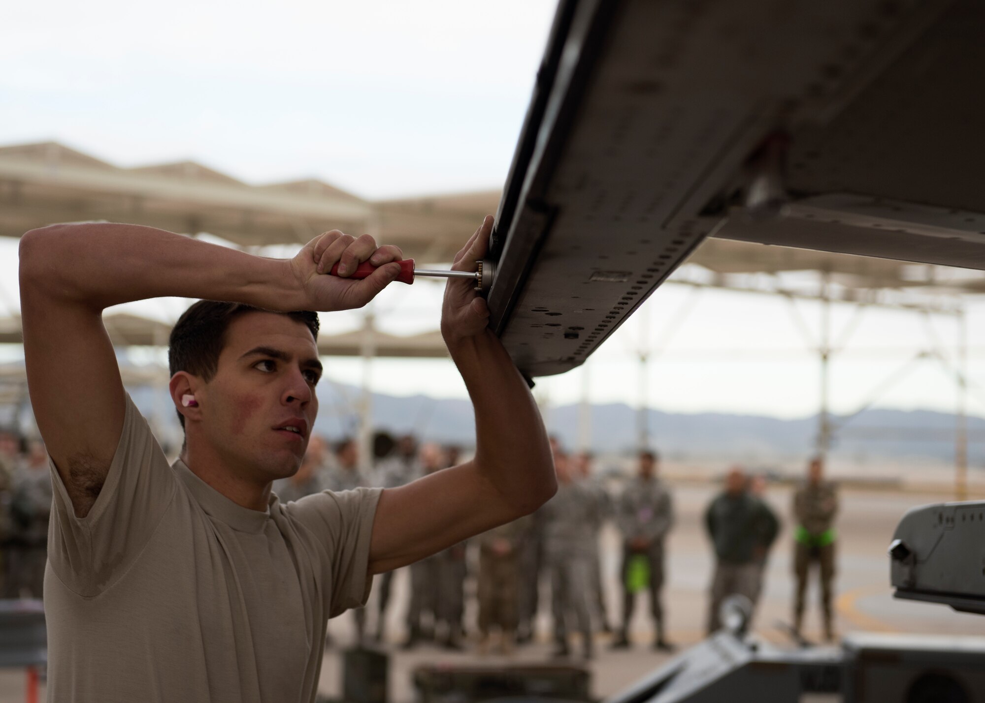 Airman 1st Class Nicholas Hyatt, 310th Aircraft Maintenance Unit load crew team member, prepares an F-16 Fighting Falcon for munition loading at Luke Air Force Base, Ariz., Jan. 10, 2019.
