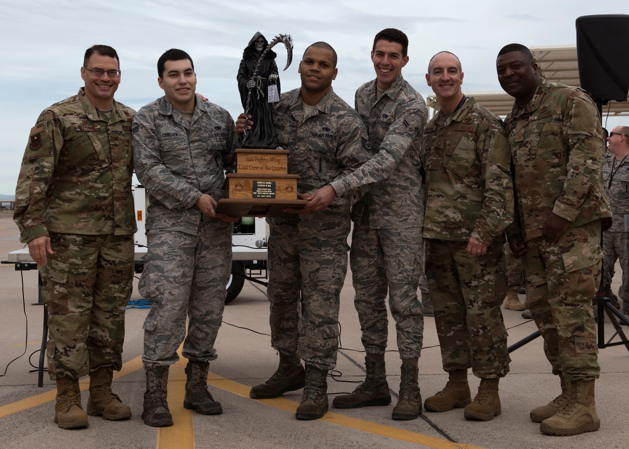 The 310th Aircraft Maintenance Unit load crew team accepts a trophy after the 56th Fighter Wing Quarterly Load Crew Competition at Luke Air Force Base, Ariz., Jan. 10, 2019.