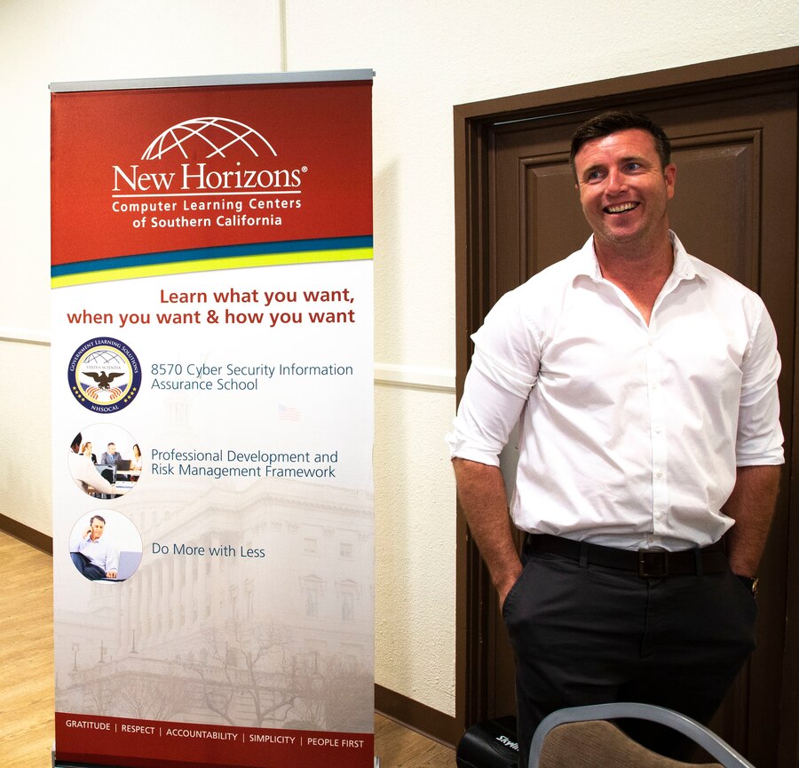 An employee with New Horizons Computer Learning Center prepares to discuss the companies new innovations during Tactical and Tech Day, aboard the Marine Corps Air Ground Combat Center, Twentynine Palms, Calif., Oct. 2, 2018. The Tactical & Tech Day gives Department of Defense contractors the opportunity to show the Combat Center’s unit leaders the newest technology available. (U.S. Marine Corps photo by Lance Cpl. Christopher Andrew Tate)