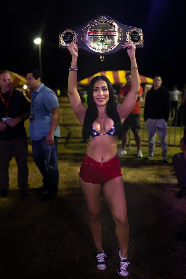 Gloria Friedly displays a champion belt at Del Valle Field, Marine Air Ground Combat Center, Twentynine Palms, Calif. on October 12, 2018. Fight Night is an annual event hosted by Marine Corps Community Services to boost the morale of service members aboard the Combat Center. (U.S. Marine Corps photo by Lance Cpl. Carley Vedro)