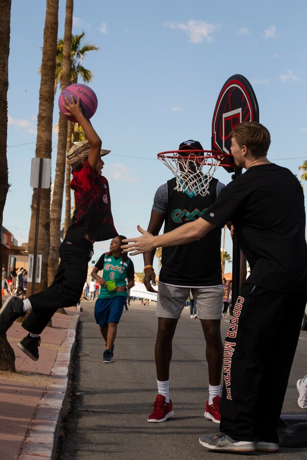 Fighting Cacti, the Copper Mountain College basketball team, interact with attendees during the 29 Palms Pioneer Day Parade in Twentynine Palms, Calif., Oct. 20, 2018. Pioneer Days started in 1937 and since then has evolved into a celebration and parade. The Combat Center and local community keep relations strong with events like these, giving them the opportunity to connect. (U.S. Marine Corps photo by Lance Cpl. Dave Flores)