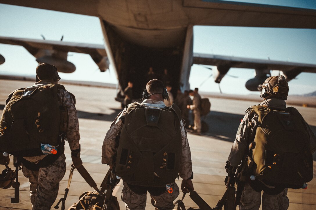 U.S. Marines with 3rd Reconnaissance Battalion, 3rd Marine Division, III Marine Expeditionary Force, walk towards a  AC-130 at Marine Corps Air Ground Combat Center, Twentynine Palms, Calif., Oct. 25, 2018, as a part of Integrated Training Exercise 1-19. The purpose of ITX is to create a challenging, realistic training environment that produces combat-ready forces capable of operating as an integrated Marine Air Ground Task Force. (U.S. Marine Corps Photo by Sgt. Joshua Elijah Chacon)