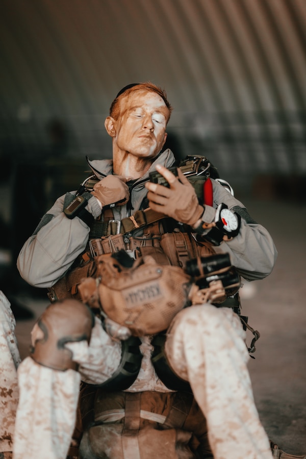 A Marine with 3rd Reconnaissance Battalion, 3rd Marine Division, III Marine Expeditionary Force, applies camouflage paint to himself at Marine Corps Air Ground Combat Center, Twentynine Palms, Calif., Oct. 25, 2018, as a part of Integrated Training Exercise 1-19. The purpose of ITX is to create a challenging, realistic training environment that produces combat-ready forces capable of operating as an integrated Marine Air Ground Task Force. (U.S. Marine Corps Photo by Sgt. Joshua Elijah Chacon)