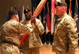 Maj. Gen. Flem B. "Donnie" Walker, Jr., commanding general, left, passes the colors to Command Sgt. Maj. Bernard P. Smalls, Sr., both of the 1st Theater Sustainment Command, during the Assumption of Responsibility Ceremony, Jan 11. Smalls has been working as the CSM for the past 60 days and was officially recognized as the Command Sgt. Maj. for the 1st TSC.
