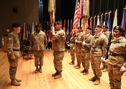 Sgt. Maj. Marde Stephens, right, prepares to pass the colors to Maj. Gen. Flem B. "Donnie" Walker, Jr., commanding general, both of the 1st Theater Sustainment Command during the during the Assumption of Responsibility Ceremony, for Command Sgt. Maj. Bernard P. Smalls, Sr. Smalls has been working as the CSM for the past 60 days and was officially recognized as the Command Sgt. Maj. for the 1st TSC.