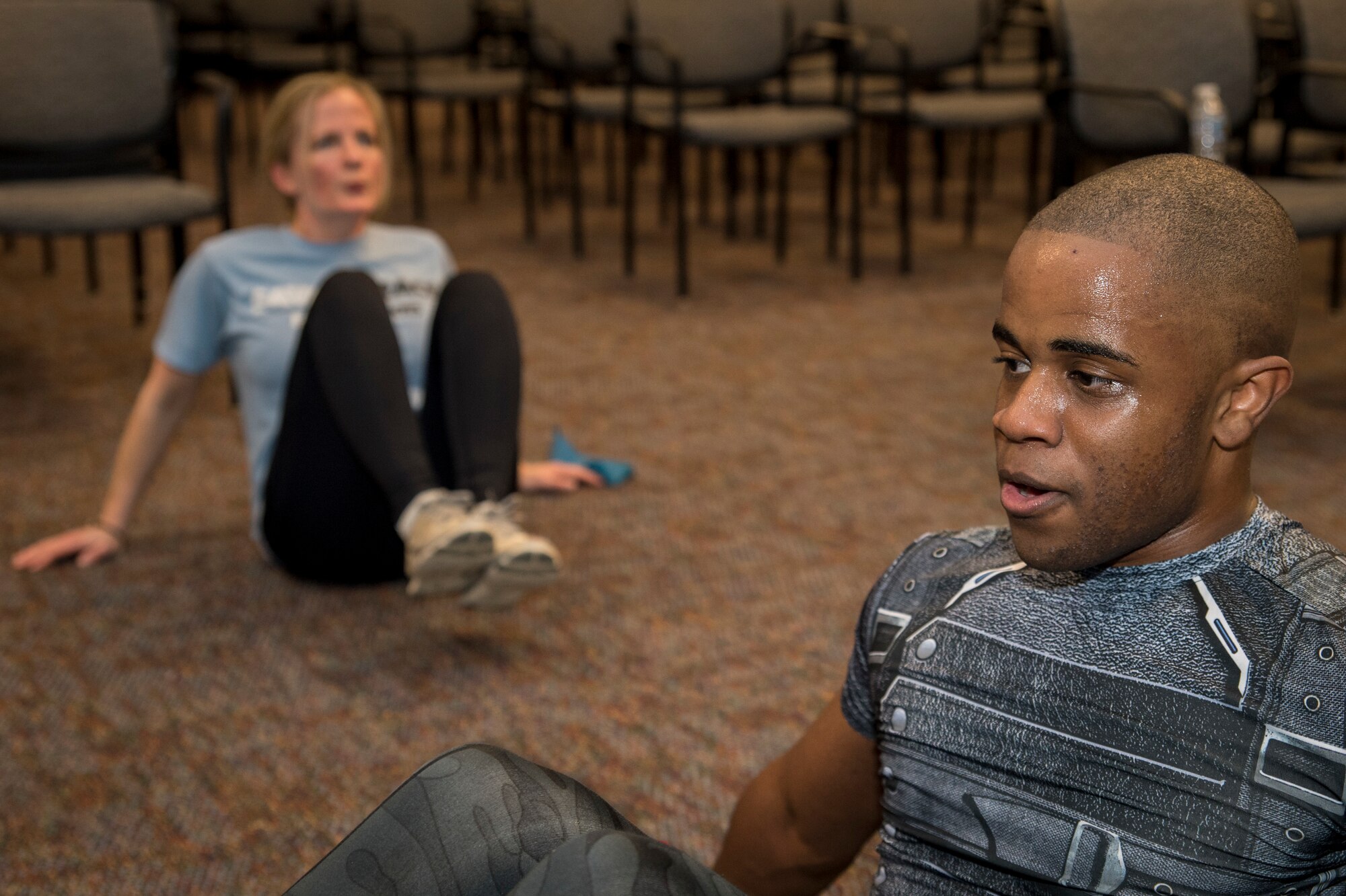 Captain Deborah K. Hautanen, 514th Force Support Squadron operations officer, and Senior Airman Joshua Hewlett, 514th FSS personnel specialist, both with the 514th Air Mobility Wing, Joint Base McGuire-Dix-Lakehurst, N.J., perform reverse crunches during a High Intensity Interval Training class, January 12, 2019. Hewlett offers the HIIT class on alternating Saturdays of the Unit Training Assembly weekend in the auditorium of the 514th FSS building. (U.S. Air Force photo by Senior Airman Ruben Rios)